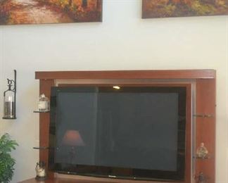 Flat screen television, media stand, large canvas wall decor