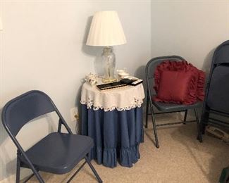 Two of 5 folding chairs, small round table, lamp