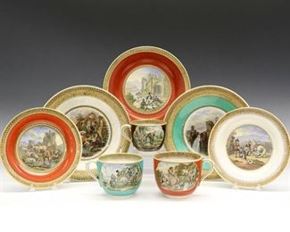 Eight Pieces of 19th Century Prattware.  English pottery transfer-decorated tableware with polychrome scenes with accent colors of orange, chocolate brown, and green.  Pieces include plates and cups of varying sizes, two plates are stamped "No. 123"; all plates are with added attachments to be mounted to a wall.  Wear to the decoration and surface scratches, crazing and discoloration evident.  Plates are up to 8 1/2" diameter, cup are up to 3 1/2" high. 