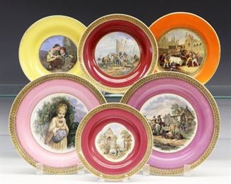Six 19th Century Prattware Plates.   English pottery transfer-decorated plates and trivets with polychrome scenes, some with accent colors of orange, pink, puce, and yellow. One plate stamped "Pratt 123 Fenton", one other with faint impressed oval mark.  Plates with added attachments to be mounted to a wall.  Wear to the decoration and some surface scrathes, four with crazing one of which with some discoloration verso, one larger plate with flaw at rim.  From 6 1/4" to 8 3/4" diameter.  
