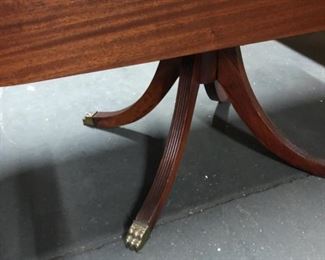 Wood dining table with two fold-down leafs. Detail of lion foot ornaments.