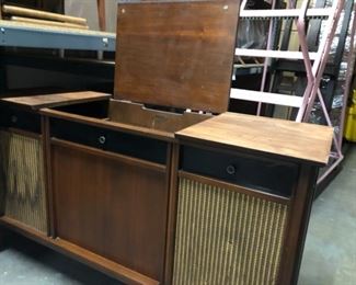 Vintage record player table with vinyl record storage and speaker cabinets.