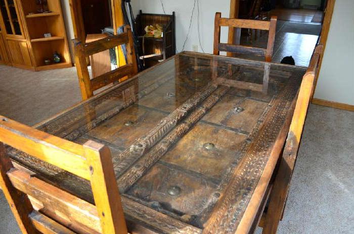 This is a Tibetan monastery door inset into a table with a glass top.  This table set comes from tibet.