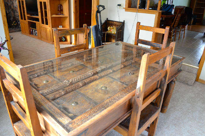 This is a Tibetan monastery door inset into a table.  This table set comes from tibet.