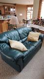 Teal leather love seat.