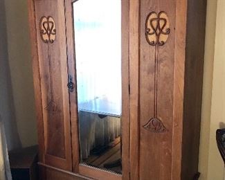 Antique armoire with mirror on center door & large drawer at bottom (80”H, 54”W, 21”D) Comes apart for moving & transport.