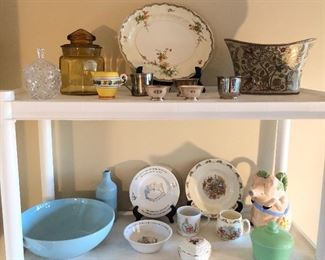 Emile Henry pale blue bowl & cruet, Wedgwood Peter Rabbit & Royal Doulton Bunnykins kids dishes, jadite round jar with lid, “papal pig” pitcher. Top row: amber glass storage glass, silver plate baby cups & more