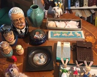 Collectibles: Bill Clinton nesting doll, Rookwood 1930 green vase, Roldan shepherd doll, Shackman “Sleepy Head” doll in box, turquoise Crown TR-555 transistor radio w/ case, bunny ornaments, Toledo Ware compact 