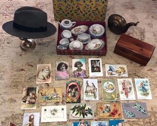 More fun finds: a sampling of the antique holiday postcards (Xmas, Easter & more), Borsalino men’s hat, vintage kids tea set w/ orig. box, big brass snail, Lane mini cedar chest