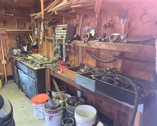 Garage full of tools, wood, doors, building supplies