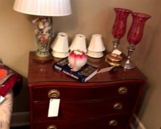 Mahogany bachelor’s chest with oriental lamp and pair of sterling and cranberry hurricane lamps