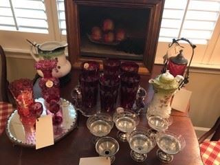 Oil painting of peaches and grapes, cranberry glass, hand painted pitcher, and sterling sherbets