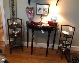 Demi lune table flanked on each side by antique muffin stands