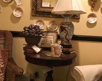 Mahogany drum table with glow feet and rope inlay circling top; monkey lamp with silk shade; copper patina