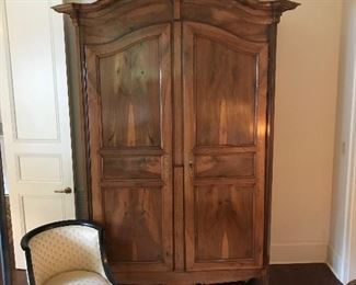 19th Century Louis XV walnut armoire of MONUMENTAL size with arched cavetto molded cornice and arched paneled doors  on raised scrolled feet.  