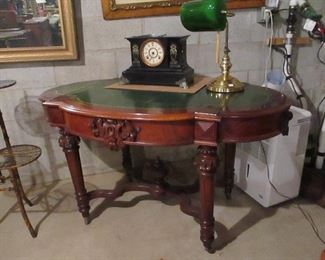 desk with green leather top , antique french clocks