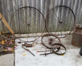 Some items found in back building. Iron wheels, milk cans, hand push cultivator, etc