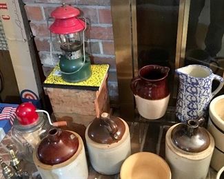 ONE OF SEVERAL COLEMAN LANTERNS, CROCK JUGS, AND MORE.