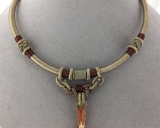 Pietersite set in raw copper pendant includes neck piece.