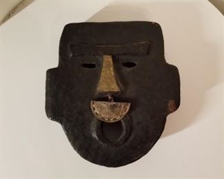 Maker's name on back, 1/2 circle hangs from nose. S. American mask