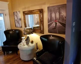 Two wing back black matching chairs, wicker table w/ glass top, large decorative mirror