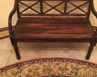 Teak bench, round Oriental carpet