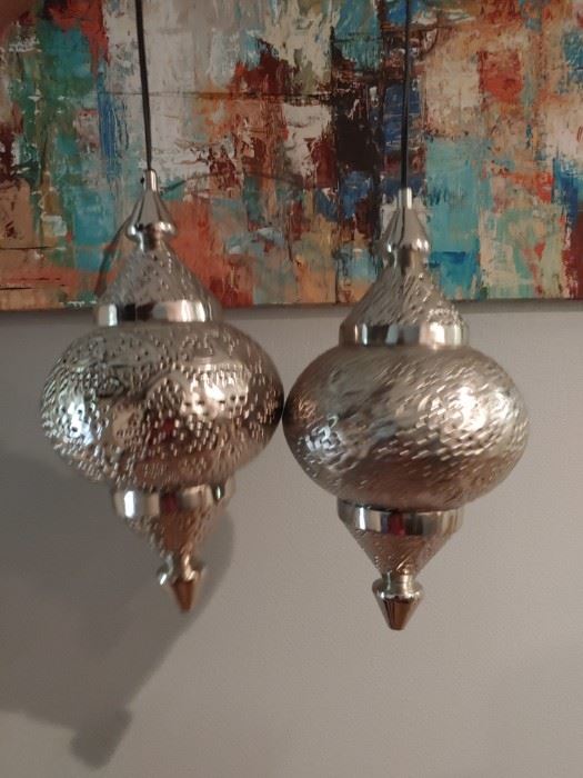 Matching silver hanging lights. Work perfectly fine. Opens from top and bottom in order to change the light or alter to remove bottom and become decorative table piece. 