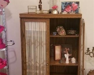 Small cabinet with glass doors and vintage German curtains