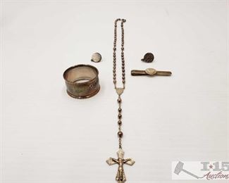 203: 	
.900 Cufflinks and Other Sterling Silver Items
.900 cufflinks and Sterling Silver napkin holder, rosary and money holder Cufflinks weigh approx 10.3g Everything else weighs approx 54.6g together 
J24 2 of 5