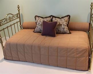 Polished brass headboards make up a custom made day bed with trundle bed.  Custom made comforter and bolster pillow to be sold with bed.  