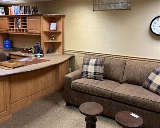 The office with beautiful sofa, books and office supplies. 