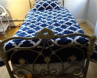 Twin size bed with a head and foot gold-colored frame. Comes with a mattress and base set.