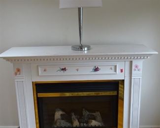 Portable, electric fireplace that looks quite authentic with a very realistic flame on the wood. The flame intensity can be adjusted (can provide a large or small flame). Entire set can be dismantled and moved. It can also blow warm air. The temperature and speed of the air blowing can be controlled. This is a good backup heating unit if the central heating is unavailable.