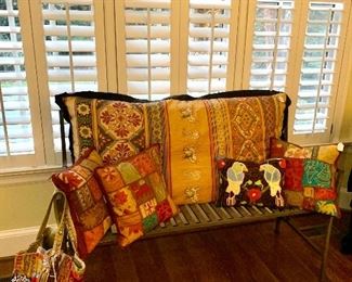 Bench slathered in super cool pillows!!!!Neat totes and purses too!