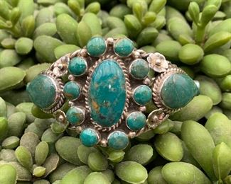 Vintage sterling silver cuff bracelet with floral motif, Native American. Not sure of the stones but they may be green turquoise.