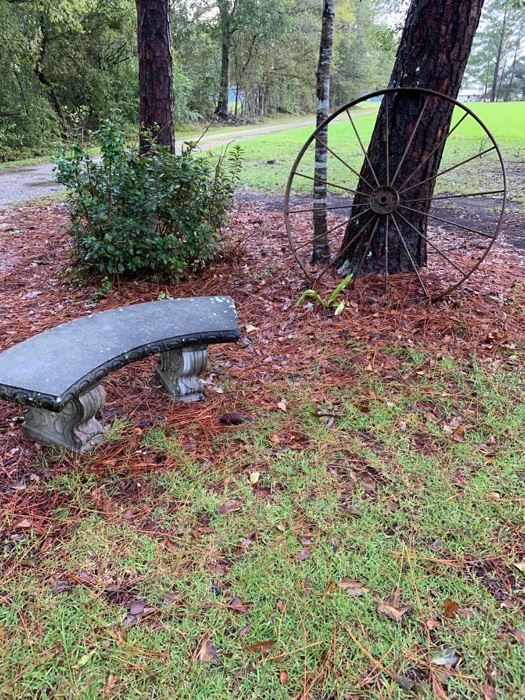 Several wagon wheels and outdoor benches