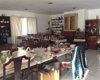 Dishes, vintage old books, roll top desk with us matching cabinet. Jars and things.