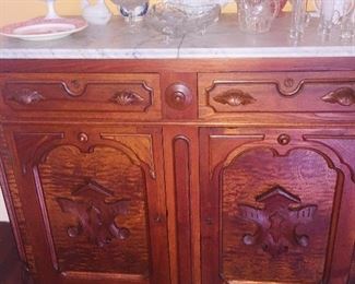 marble top sideboard with lots of early glassware