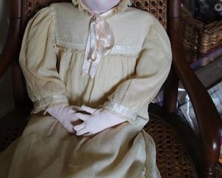 Early 20th century porcelain bisque doll, home spun dress