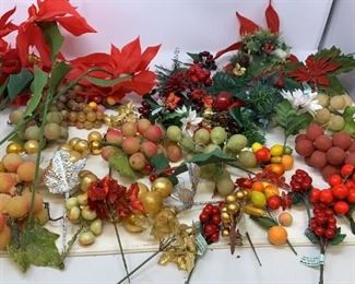 Assortment of fake flowers, fruits, etc for