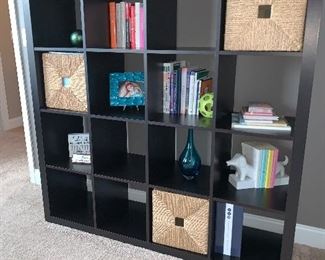 16 cubed shelving unit  with straw pull outs, other decorative items