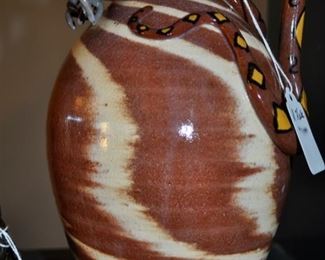 Swirl jug with decorated snake.