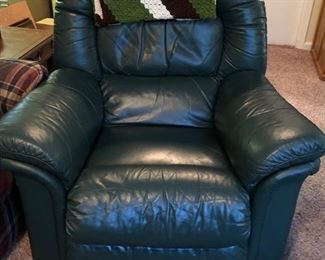 Lazy Boy green leather recliner w/ crocheted green & brown afghan over the top. 