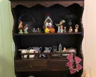 Small wooden hutch displaying antique salt & pepper shaker collection, crystal basket & tall dish, & other small household ornaments.