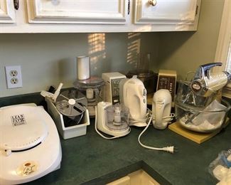 2 Electric hand mixers, stand mixer, 2 large food processors & one w/ several attachments. One small food processor & a George Foreman 2-serving classic plate electric grill. 