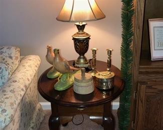 One of 2 matching oval end tables, small lamp w/ shade, 2 matching bird figurines,  antique wooden press, 2 brass candle sticks & brass incense container.