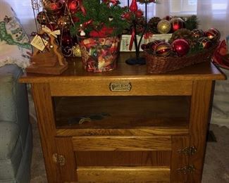 Oak side table w cabinet & Christmas decor items. 