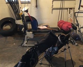 Bow flex exercise system, 2 Jr. golf club sets, tennis racket, sleeping bag, & 2 car tires. 