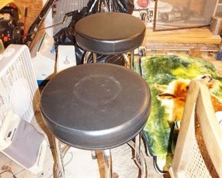 Two black stools, fan