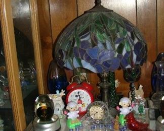 Tiffany style lamp, clocks, figurines 